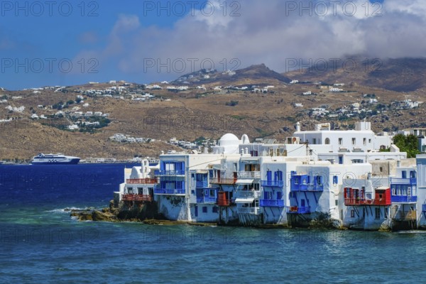 Mykonos, Cyclades, Greece - Little Venice is a picturesque neighborhood in Mykonos Town with colorful houses that stand right by the sea and are reminiscent of Venice. Little Venice is located on Alefkandra Bay next to the famous windmills of Mykonos. Mykonos is part of the Cyclades archipelago in the Aegean Sea