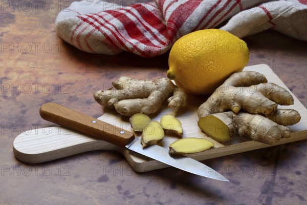 Ginger, ginger root cut with ginger slices on wooden boards