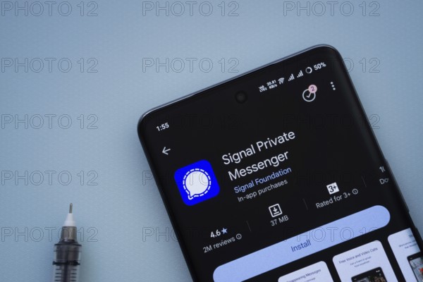 Dhaka, Bangladesh- 29 May 2025: On a blue surface, a smartphone displays the Signal app within the Google Play Store