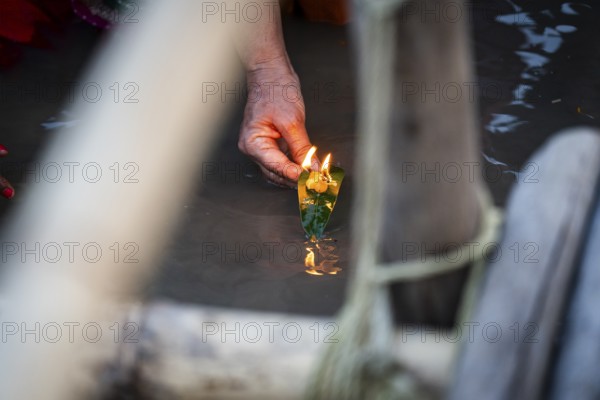 Hindu devotees gather on the banks of the Brahmaputra River to offer prayers to the Sun God on the occasion of Chhath Puja, in Guwahati, India on 27 October 2025