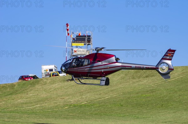 A Eurocopter EC 120B Colibri helicopter, D-HALX registration, during a flight demonstration as part of an air show on Rossfeld in Metzingen-Glems, Baden-Württemberg, Germany, for editorial use only