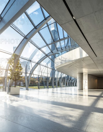 Modern architectural framework with glass and steel structure, glass facade with a greed of steel arrows, blue sky with a soft golden light of a sunrise, AI generated