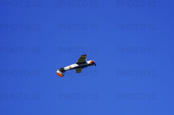 A Jakovlev Jak-52 with registration LY-HLZ during a flight demonstration as part of an air show on Rossfeld in Metzingen-Glems, Baden-Württemberg, Germany, for editorial use only