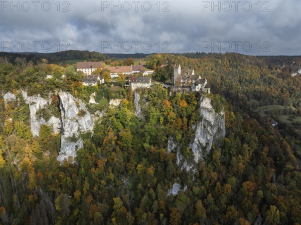 Aerial view of Werenwag Castle and former Werenwag Castle on a rocky spur in the Upper Danube Valley, surrounded by autumnal vegetation and clouds of fog, Sigmaringen district, Baden-Württemberg, Germany