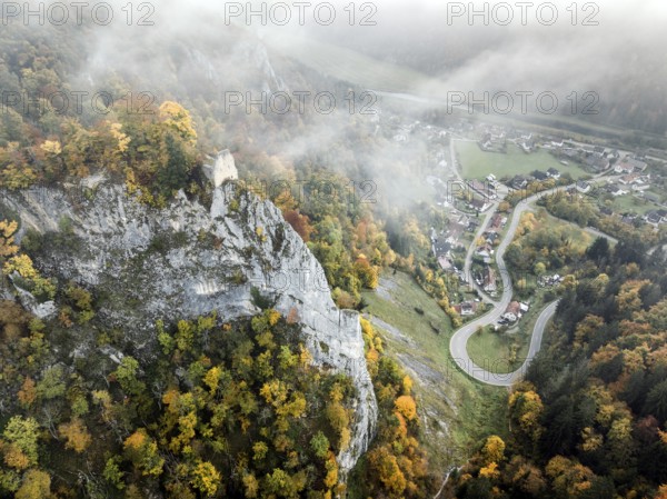 Aerial view of the viewpoint, shovels and Hausen Castle, also known as the Hausen ruins, surrounded by autumnal vegetation and clouds of fog, a ruin of a castle above the village of Hausen in the valley in the Upper Danube Valley, Beuron, Sigmaringen district, Baden-Württemberg, Germany