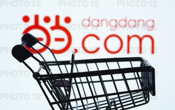Dhaka, Bangladesh- 03 Oct 2025: Silhouette of a shopping cart in front of the Dangdang.com logo, symbolizing ecommerce and online shopping