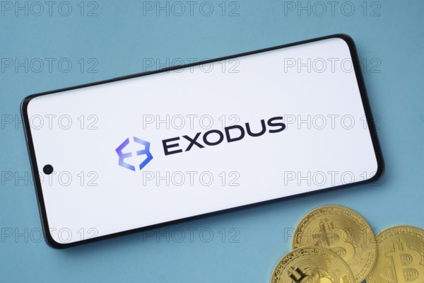 Dhaka, Bangladesh- 06 Sep 2025: Exodus logo on smartphone screen near Bitcoin coin and QR code on blue background
