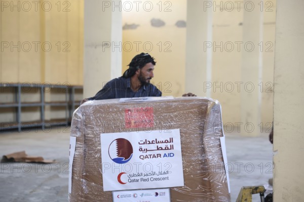 Relief workers unload boxes of medical aid provided by Qatar at Damascus International Airport, part of the humanitarian bridge supporting Syria's recovery and reconstruction after the fall of Bashar al-Assad, Damascus, Damascus, Syria