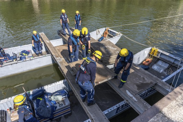 Construction of a multi-purpose pontoon, the specialist group for water hazards, in Düsseldorf, the motorised pontoon can be used as a ferry for people or equipment, as a working platform or bridge, during the major exercise FÜLEX25, lasting several days, of the THW, Technisches Hilfswerk, Landesverband North Rhine-Westphalia, over 3500 volunteers from the 127 North Rhine-Westphalia local associations practise many different deployment scenarios over 4 weekends