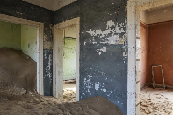 At Kolmanskop, the abandoned ghost town of the diamond days of the early 1900 and of German origin. Inside the restricted Diamond Area east of the coastal town of Lüderitz. Namib Desert, Namibia