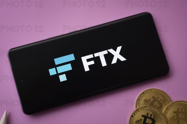 Dhaka, Bangladesh- 03 Saep 2025: FTX logo on smartphone screen near Bitcoin coin and QR code on background