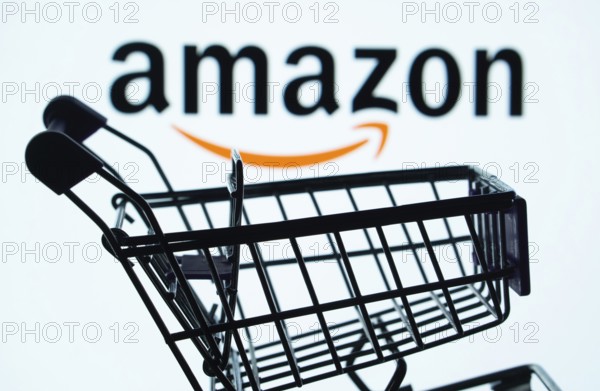 Dhaka, Bangladesh- 03 July 2025: Silhouette of a shopping cart in front of the Amazon logo, symbolizing ecommerce and online shopping