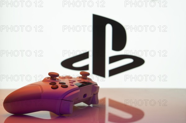 Dhaka, Bangladesh- 26 July 2025: Game controller in front of PlayStation logo on a background