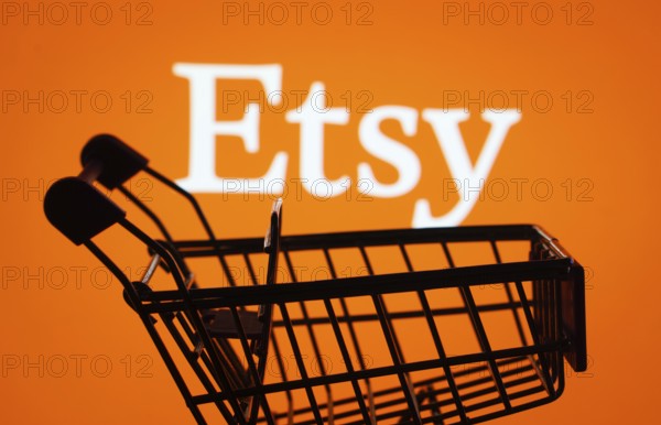 Dhaka, Bangladesh- 03 July 2025: Silhouette of a shopping cart in front of the Etsy logo, symbolizing ecommerce and online shopping