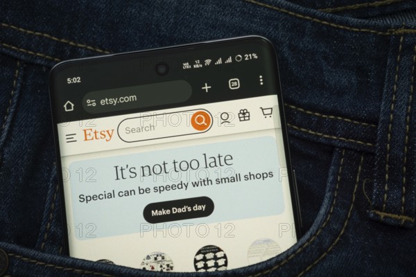 Dhaka, Bangladesh- 15 June 2025: A smartphone displaying the Etsy web interface peeks out of a denim pocket