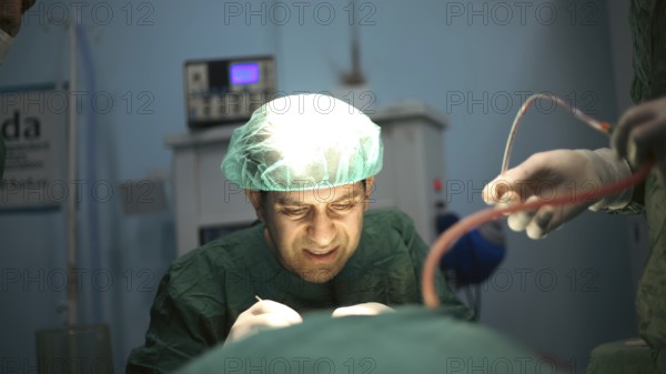 Several doctors performing a complex surgical operation inside an operating room for a displaced patient. Aleppo, Syria. October 18, 2022, Aleppo, Syria