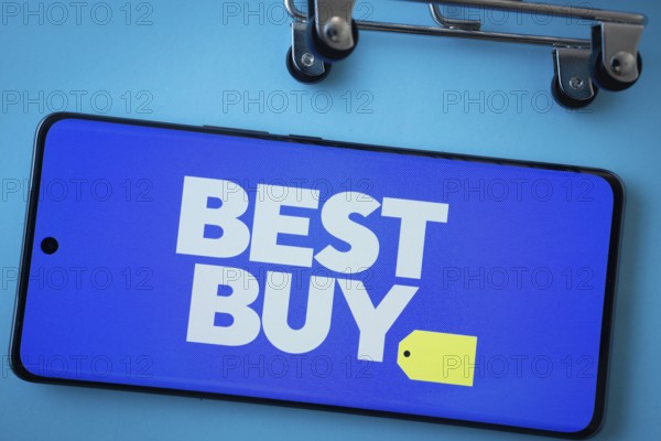 Dhaka, Bangladesh- 03 July 2025: Smartphone screen showing the Best Buy logo with shopping cart wheels on a blue background