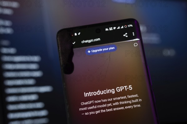 Dhaka, Bangladesh- 09 aug 2025: A smartphone screen displaying the OpenAI GPT-5 with the website is visible on a computer screen in the background