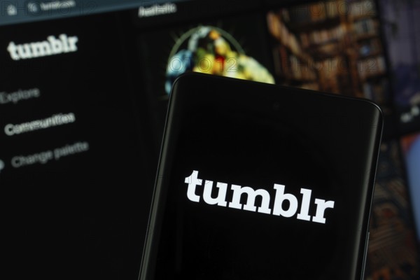 Dhaka, Bangladesh- 08 Aug 2025: Tumblr logo is displayed on a smartphone screen, with the website is visible on a computer screen in the background