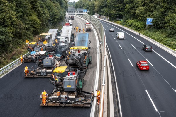 Rehabilitation of the A52 motorway near Essen, an 8 km long section between the Essen-Kettwig junction and the Essen-Ost motorway junction was completely renovated over a period of 9 years, 6 lanes, new drainage pipes, carriageway, bridges, noise barriers, traffic facilities, here the last section, direction Düsseldorf, new carriageway surface, laying of porous asphalt, whispering asphalt, at the Essen-Rüttenscheid junction, North Rhine-Westphalia, Germany