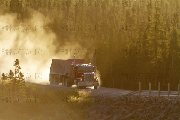 Transport truck driving on a dusty forest track, Province of Quebec, Canada, North America