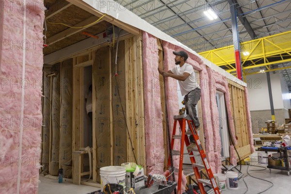 Romulus, Michigan - Workers build apartments in Ginosko Modular 's factory using modular construction methods. The units will be assembled into an apartment building in Detroit for low to moderate income households