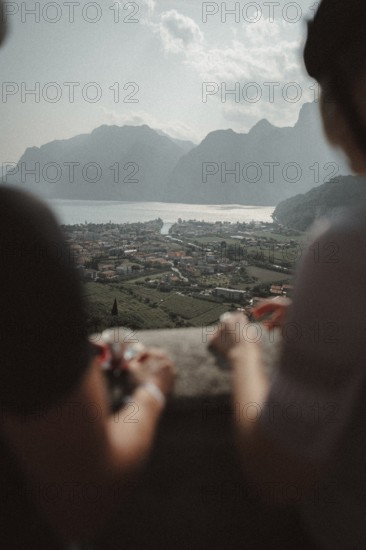 Young man taking a coffee break while riding his racing bike on Lake Garda. Sunny weather and dolce vita