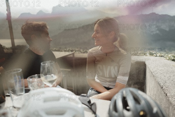Young man taking a coffee break while riding his racing bike on Lake Garda. Sunny weather and dolce vita
