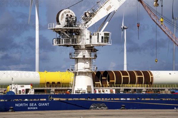 The seaport of Eemshaven, Julianahaven Basin, where the foundation structures, monopiles, for offshore wind farms are stored, which then support the actual wind turbines, the components are transported to the wind farms in the North Sea on large workboats and anchored to the seabed, where the wind turbines are then built, Eemshaven, Netherlands