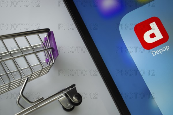 Dhaka, Bangladesh- 05 March 2025: A close up of an iPad screen displaying the depop app alongside a mini shopping cart