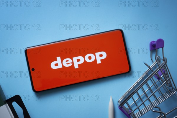 Dhaka, Bangladesh- 03 July 2025: Smartphone displaying Depop logo with shopping cart on a blue background