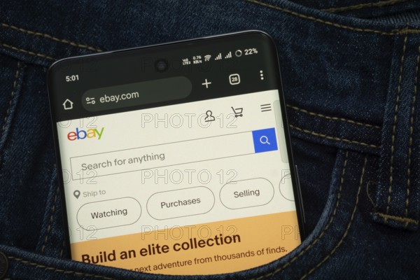 Dhaka, Bangladesh- 15 June 2025: A smartphone displaying the eBay.com web interface peeks out of a denim pocket