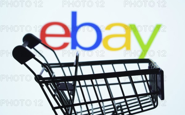 Dhaka, Bangladesh- 03 July 2025: Silhouette of a shopping cart in front of the eBay logo, symbolizing ecommerce and online shopping