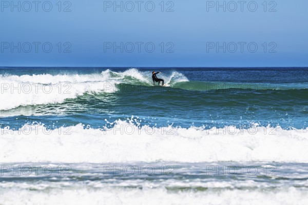 Surfer riding a wave on Contis beach, Saint Julien en Born, Saint-Julien-en-Born, Landes, France