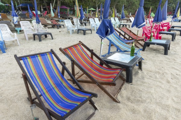 Abandoned deckchairs and parasol after sunset at Charlie Beach, Koh Mook Island, Andaman Sea, Thailand, Southeast Asia
