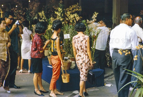 People attending flower show at the Singapore Turf Club, The 4th World Orchid Conference, Singapore, Southeast Asia, October 3-10, 1963