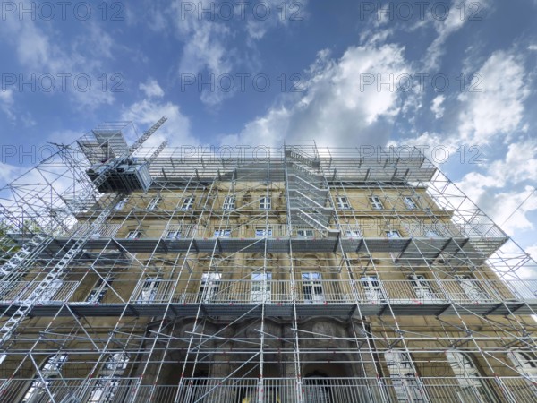 Scaffolded façade of the district court with metal platforms and stairs in Wuppertal, Germany