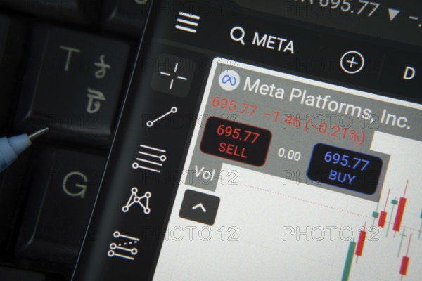 Dhaka, Bangladesh- 20 June 2025: Meta Platforms stock trading details on smartphone over a keyboard