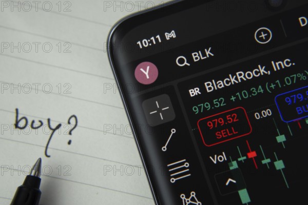 Dhaka, Bangladesh- 20 June 2025: BlackRock Inc stock trading details displayed on smartphone with handwritten note