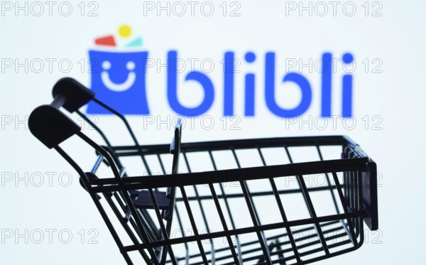 Dhaka, Bangladesh- 03 July 2025: Silhouette of a shopping cart in front of the Blibli logo, symbolizing ecommerce and online shopping