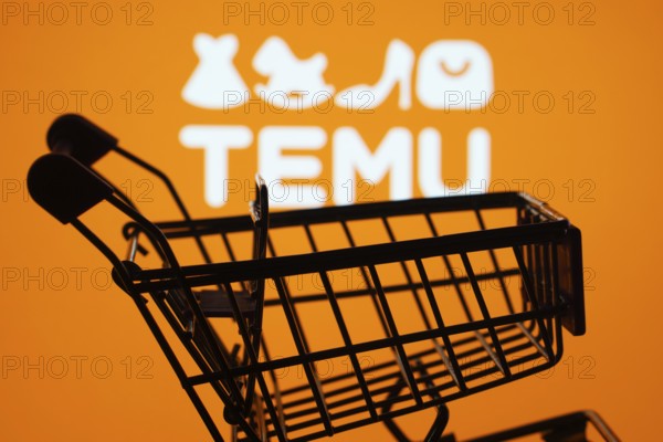 Dhaka, Bangladesh- 03 July 2025: Silhouette of a shopping cart in front of the Temu logo, symbolizing ecommerce and online shopping
