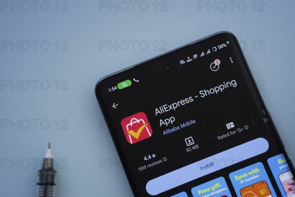 Dhaka, Bangladesh- 29 May 2025: On a blue surface, a smartphone displays the AliExpress app within the Google Play Store