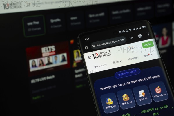 Dhaka, Bangladesh - 18 July 2025: The logo of the 10 Minute School is displayed on a smartphone screen, and the website is visible on a computer screen in the background