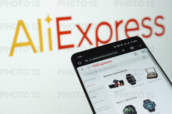 Dhaka, Bangladesh- 03 July 2025: Smartphone displaying AliExpress web interface against AliExpress logo background