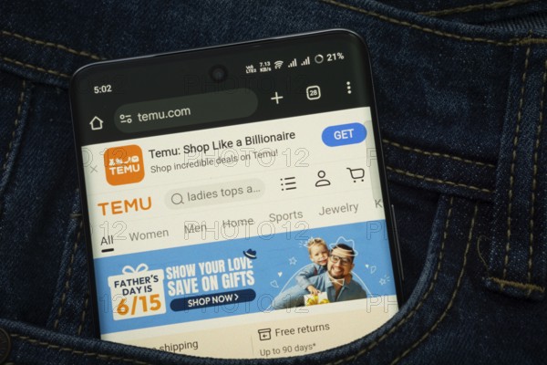 Dhaka, Bangladesh- 15 June 2025: A smartphone displaying the Temu web interface peeks out of a denim pocket