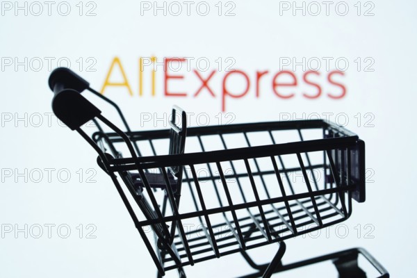 Dhaka, Bangladesh- 03 July 2025: Silhouette of a shopping cart in front of the AliExpress logo, symbolizing ecommerce and online shopping