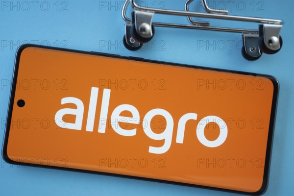 Dhaka, Bangladesh- 03 July 2025: Smartphone screen showing the Allegro logo with shopping cart wheels on a blue background