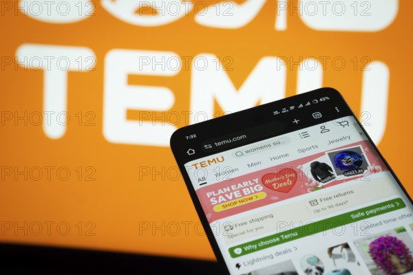 Dhaka, Bangladesh- 03 July 2025: Smartphone displaying Temu web interface against Temu logo background