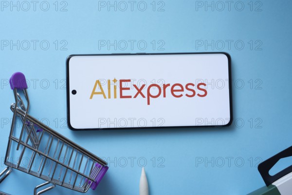 Dhaka, Bangladesh- 03 July 2025: Smartphone displaying AliExpress logo with shopping cart on a blue background