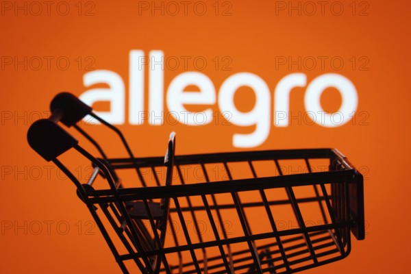 Dhaka, Bangladesh- 03 July 2025: Silhouette of a shopping cart in front of the Allegro logo, symbolizing ecommerce and online shopping